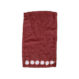 Beautiful hand-dyed itajime hemp moon linen hand towel in rust with undyed circles by kamppinen laid flat