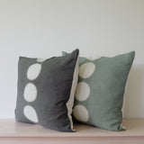 Two 18' square handdyed pillows dark green and sage with 5 undyed circles in vertical line down center, made of hemp linen by kamppinen. 